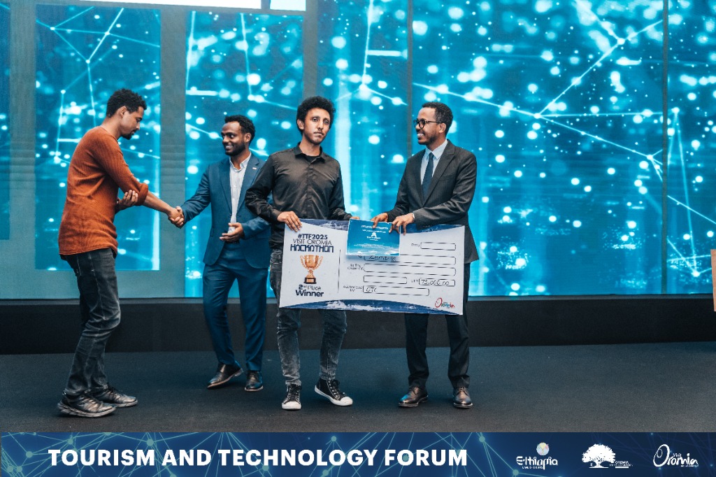 Abel Ashine receiving Hackathon check check
